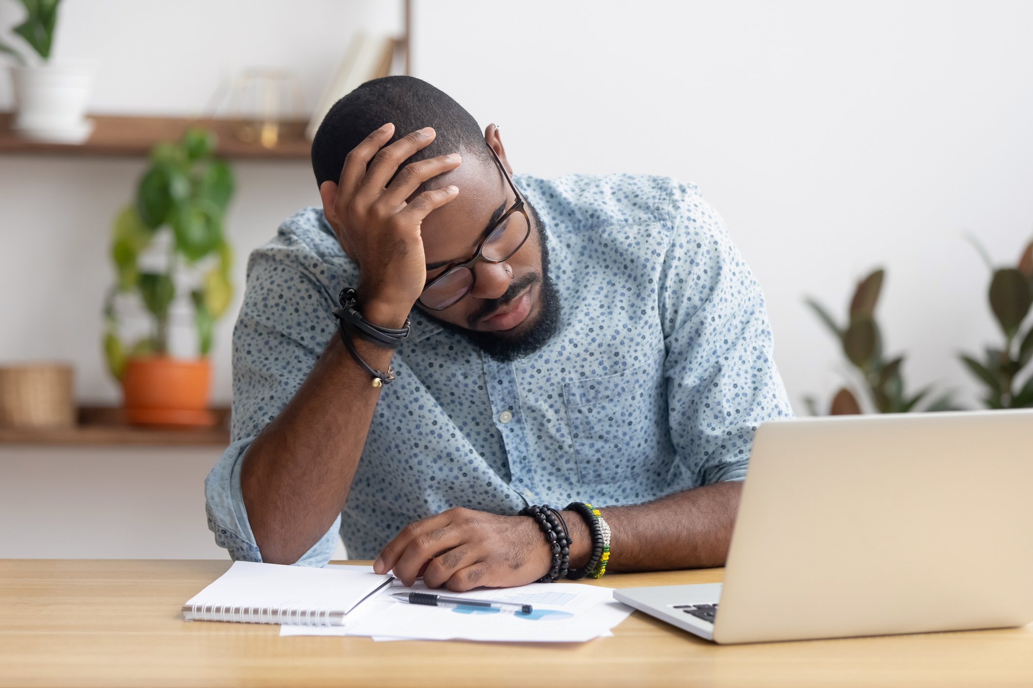 Nervous man looking at computer screen from a table