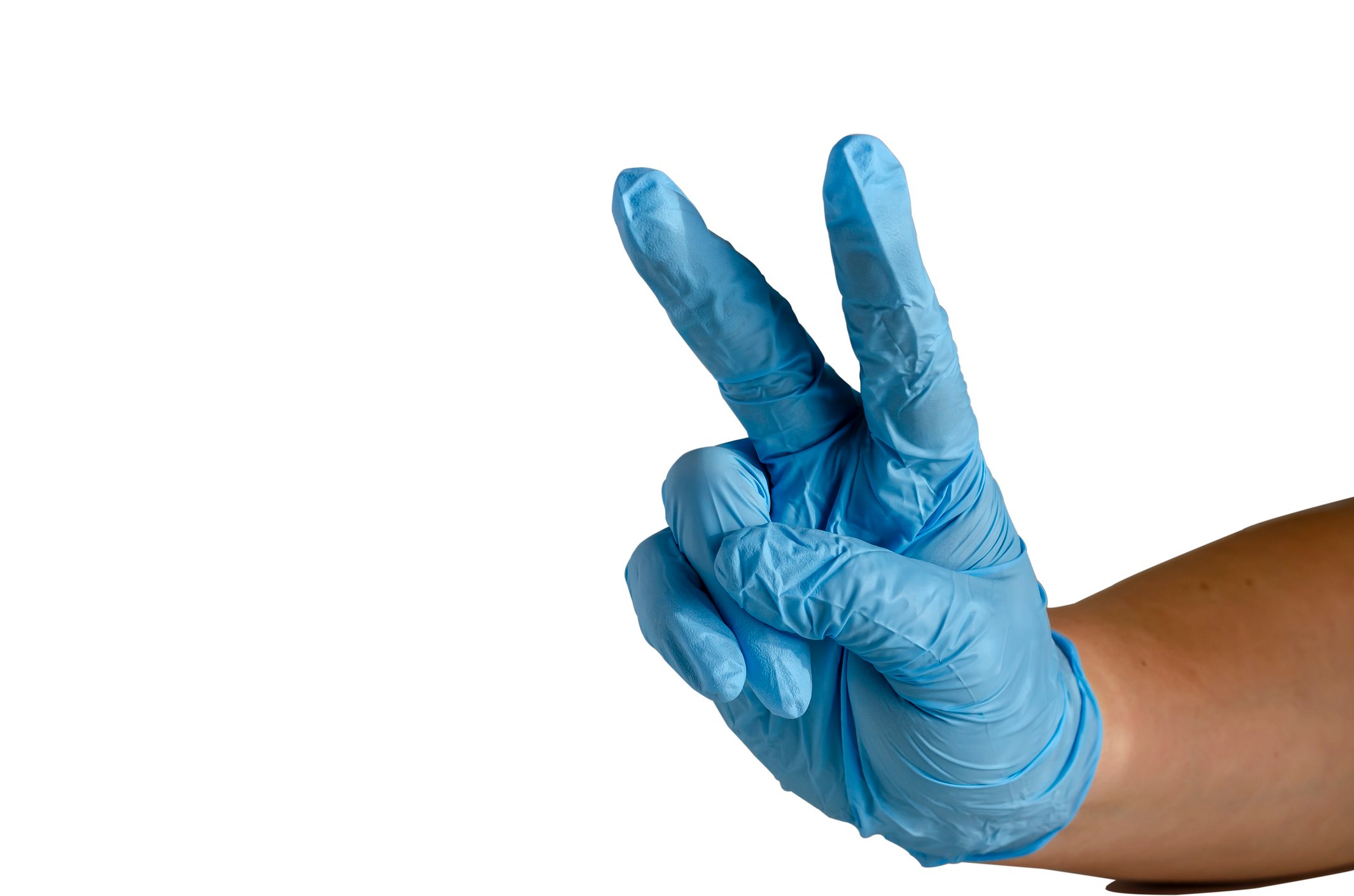 Hand wearing medical glove flashes a victory sign