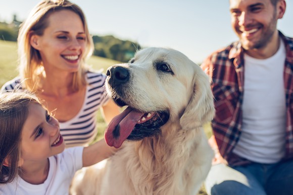 Family playing with dog. 