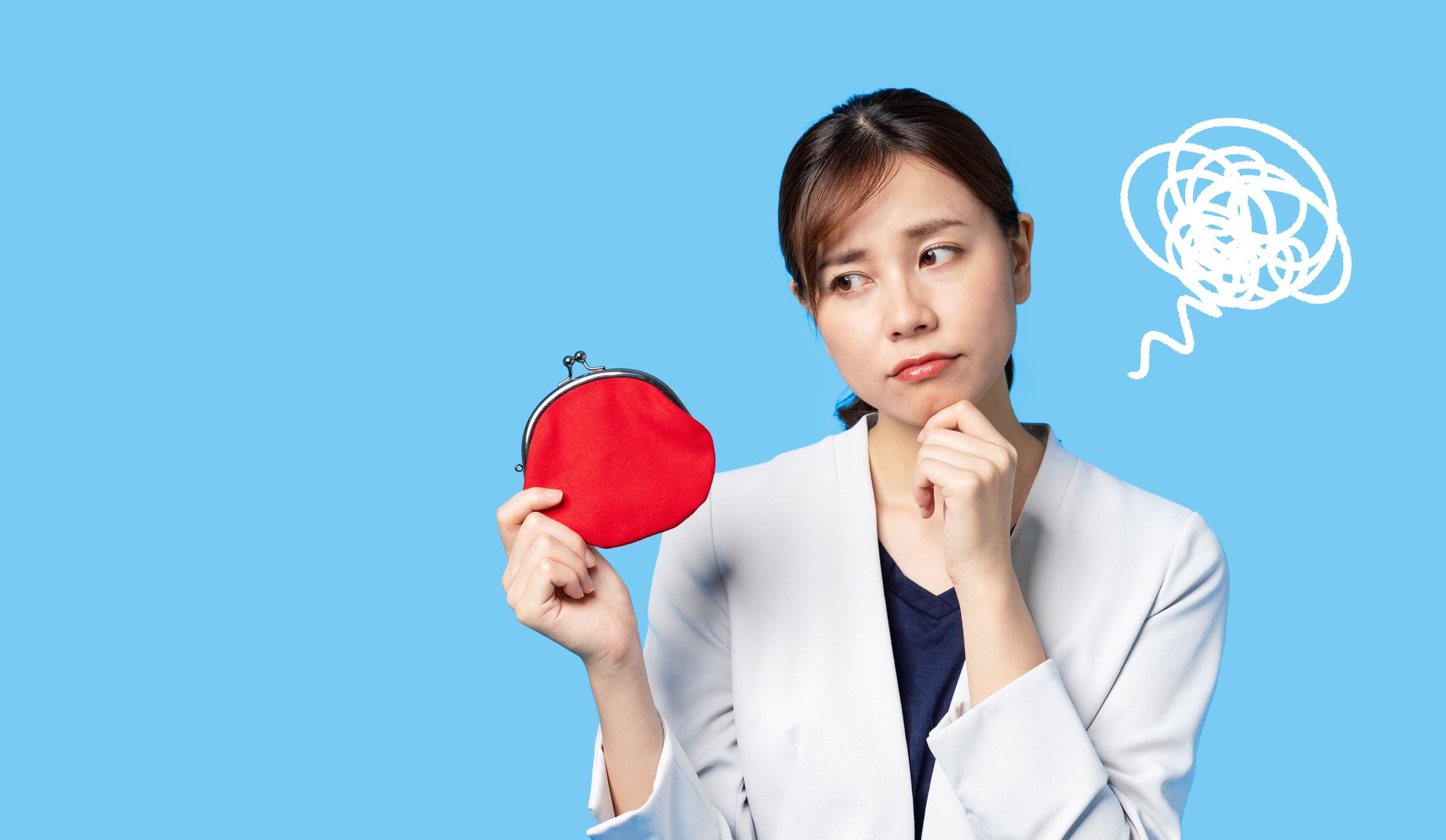 A young person in a business suit looks contemplatively at a coin purse. 