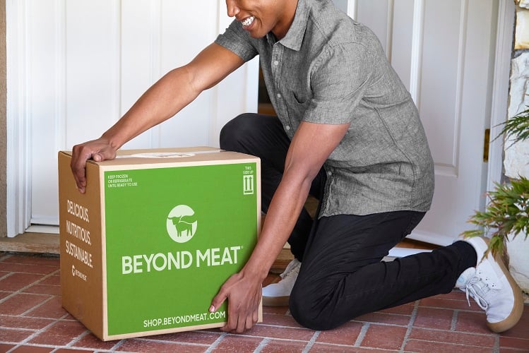 A man receives a shipment of products directly from Beyond Meat.