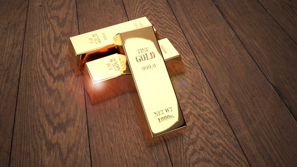 Gold bars on a wooden table.