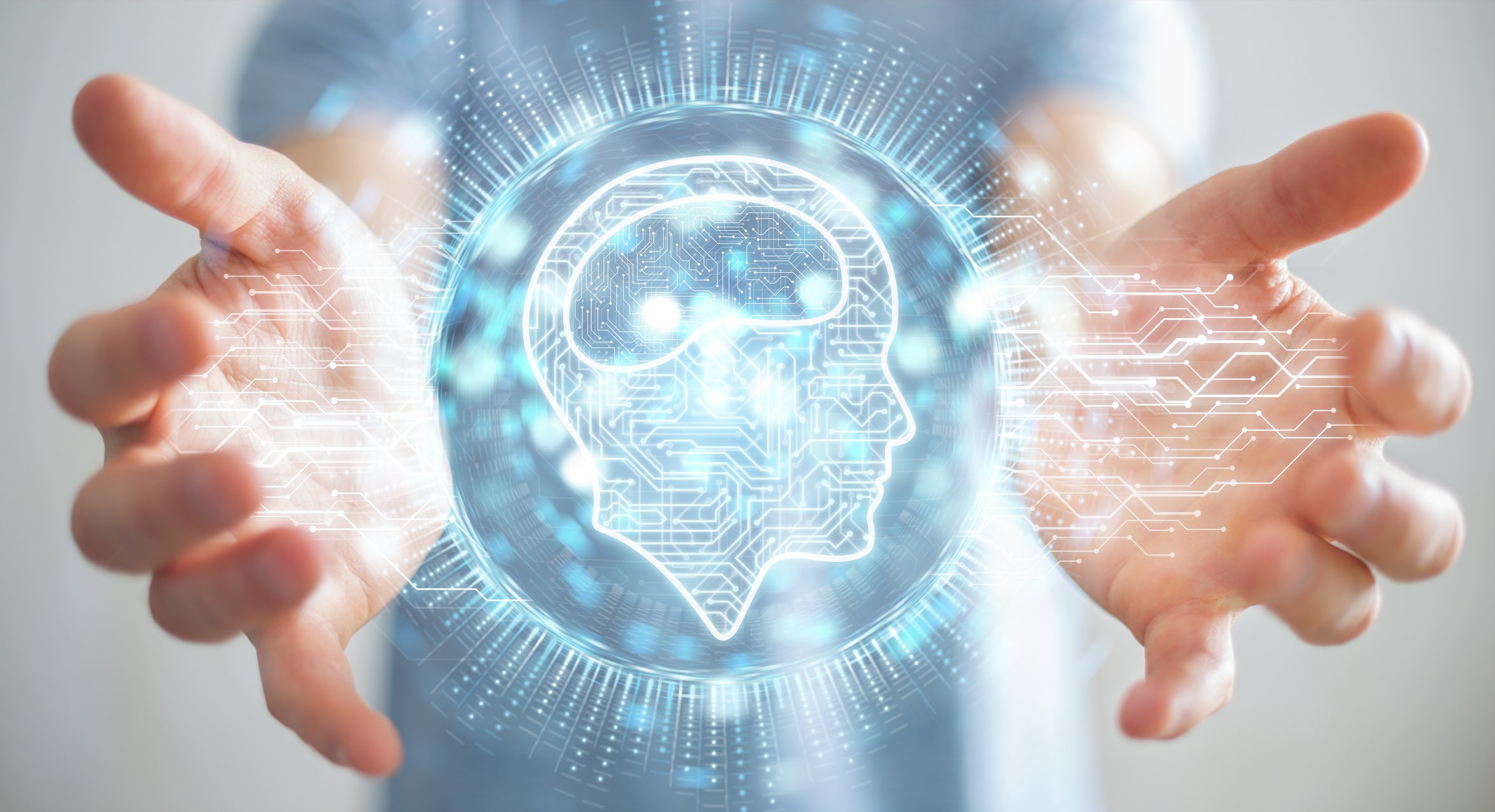 Two hands outstretched with an animation of a human head in profile between them. 