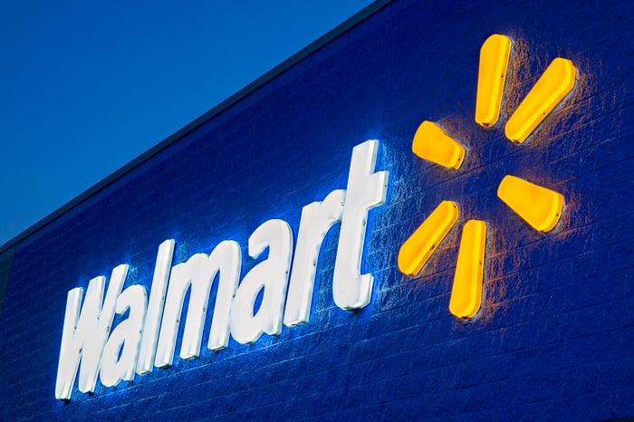 Neon Walmart sign on store exterior.