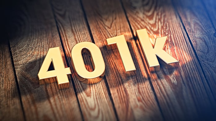 401k in gold block letters on a wooden surface