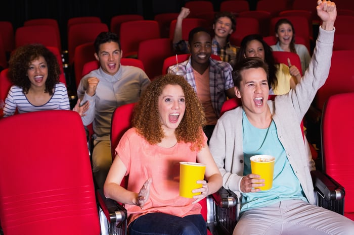 People cheering at theater