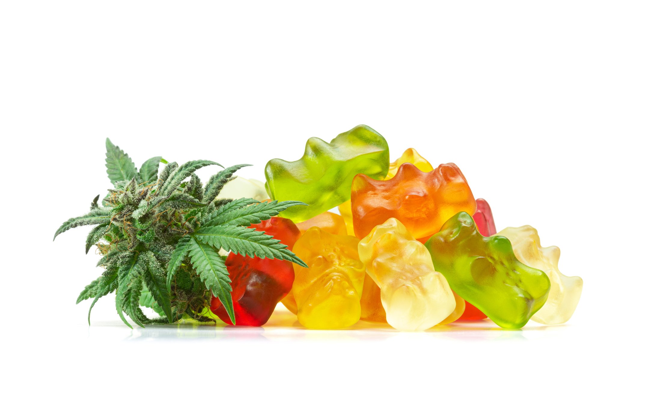 A pile of gummy candies and a marijuana leaf.