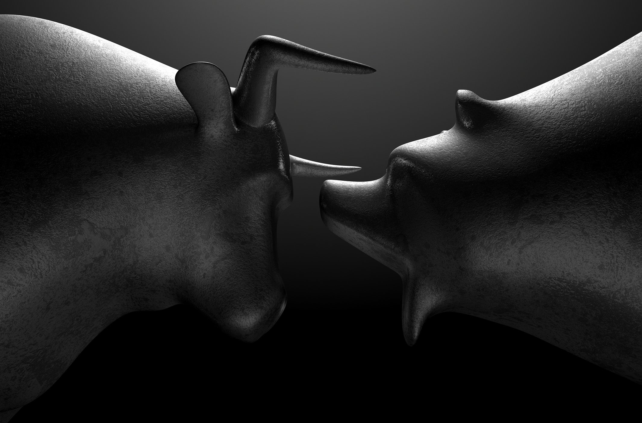 Sculptures of a bull and a bear are facing each other. 