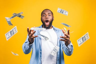 investor celebrating with money flying around