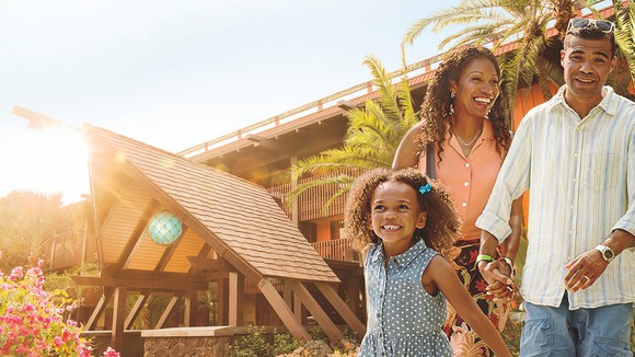 A family of three enjoying Disney's Polynesian Village Resort at Disney World.