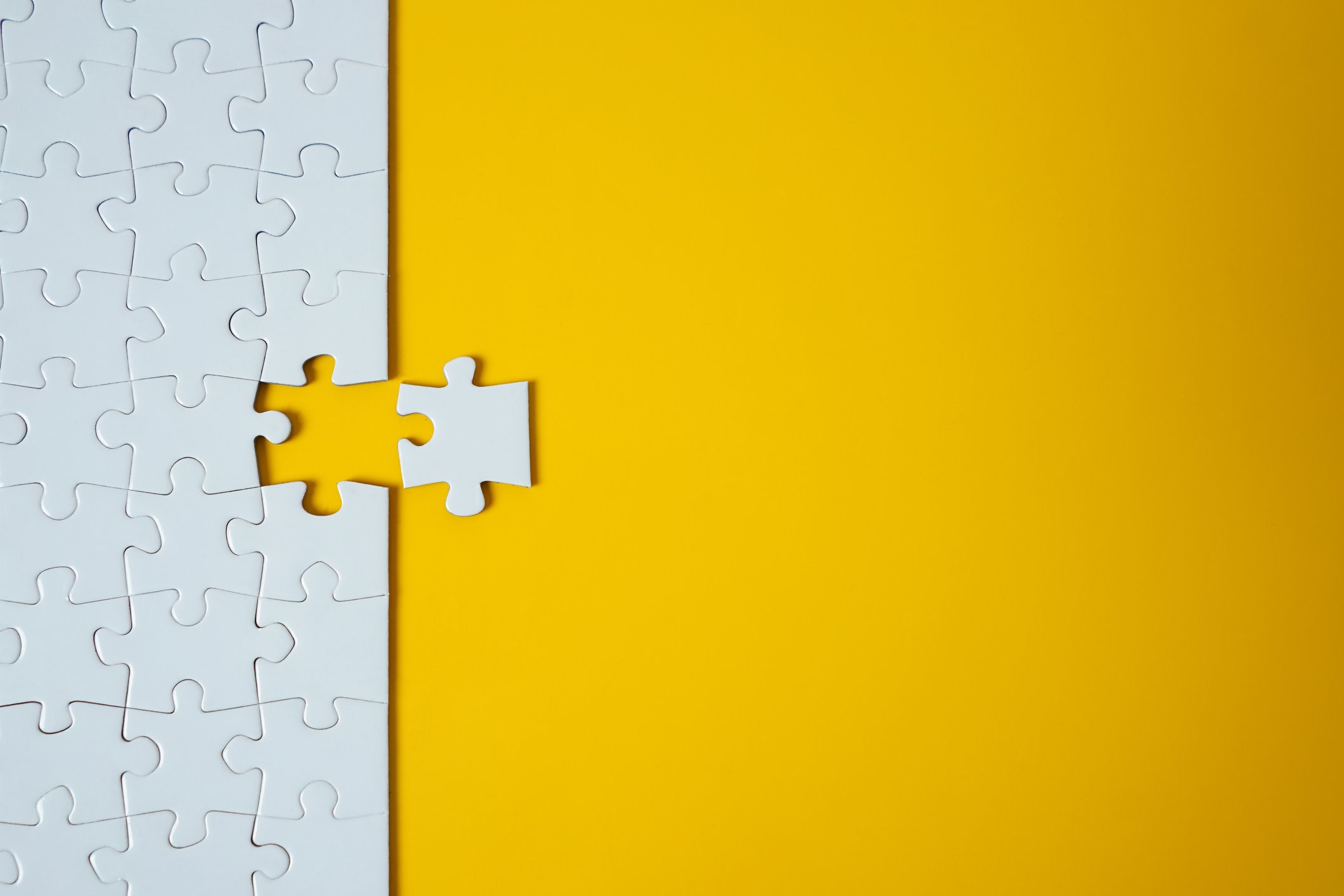 Last piece of a jigsaw puzzle being added