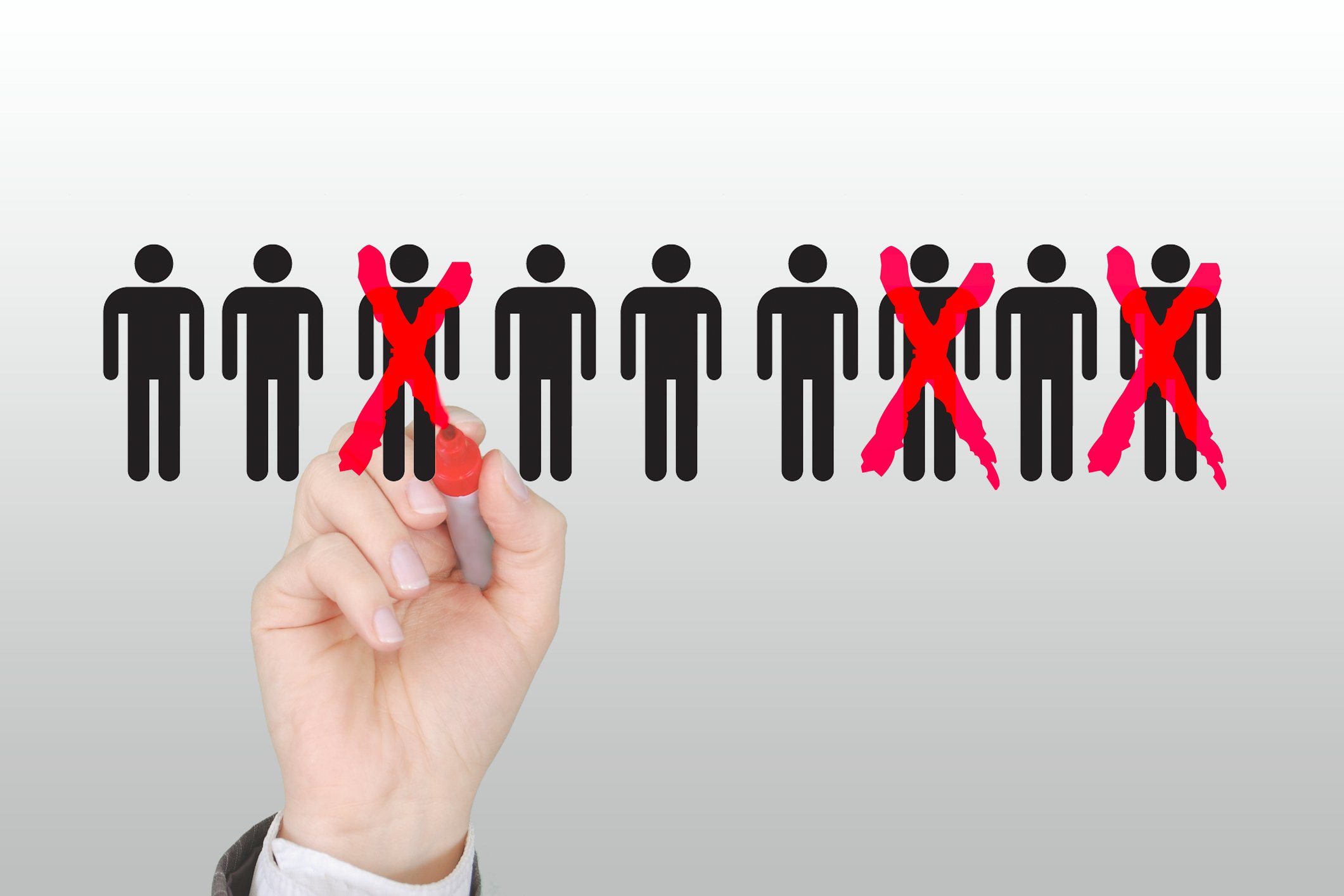 A man crosses out illustrations of people.