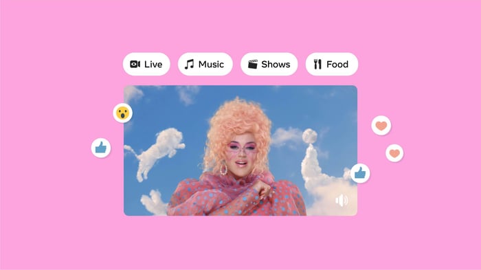 A woman dressed in pink with clouds shaped like animals in the background.