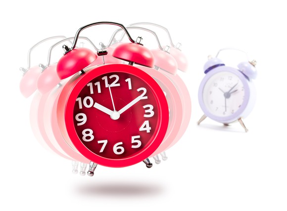 Red alarm clock ringing and vibrating