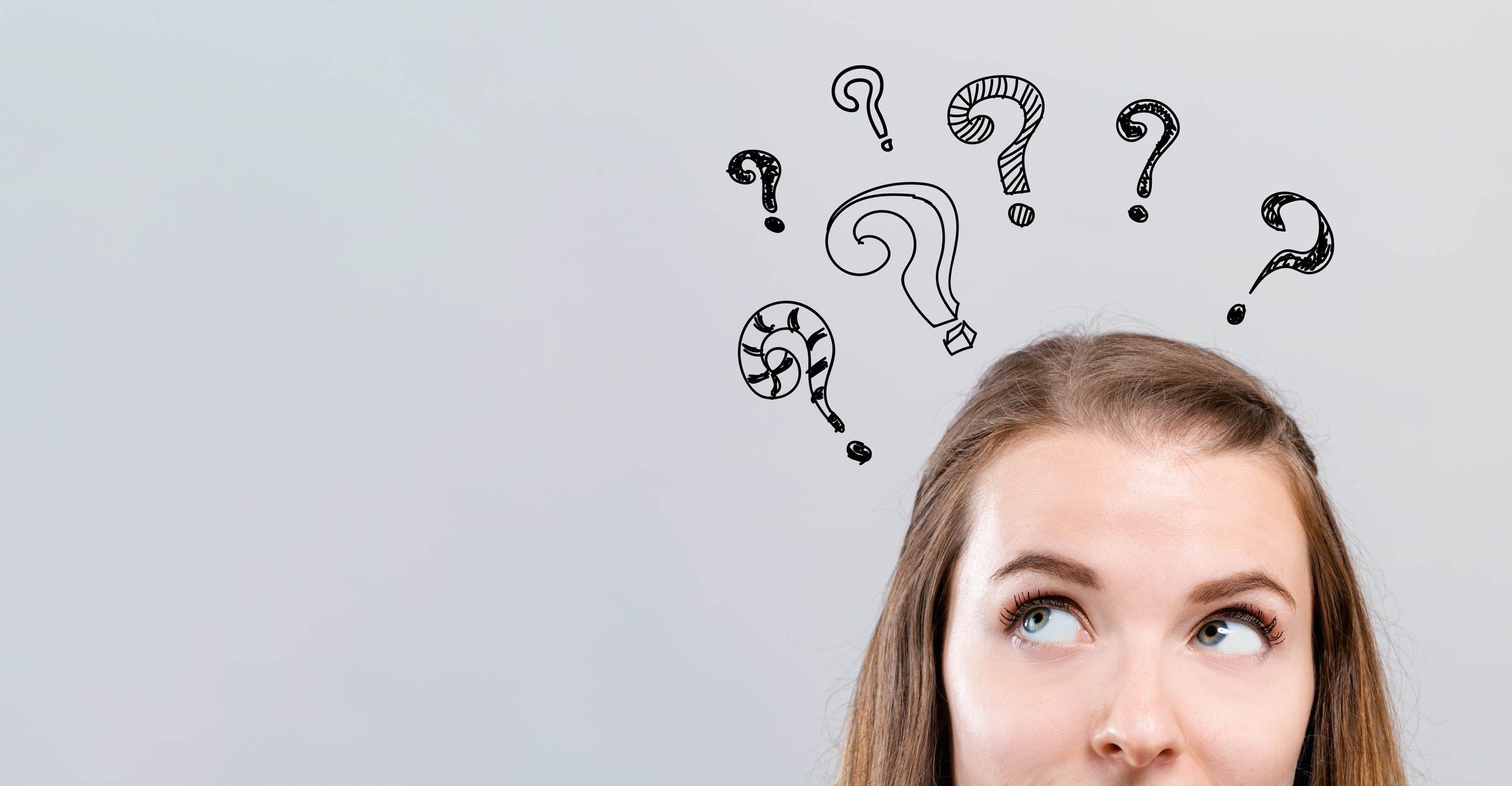Woman with question marks hovering above her head.
