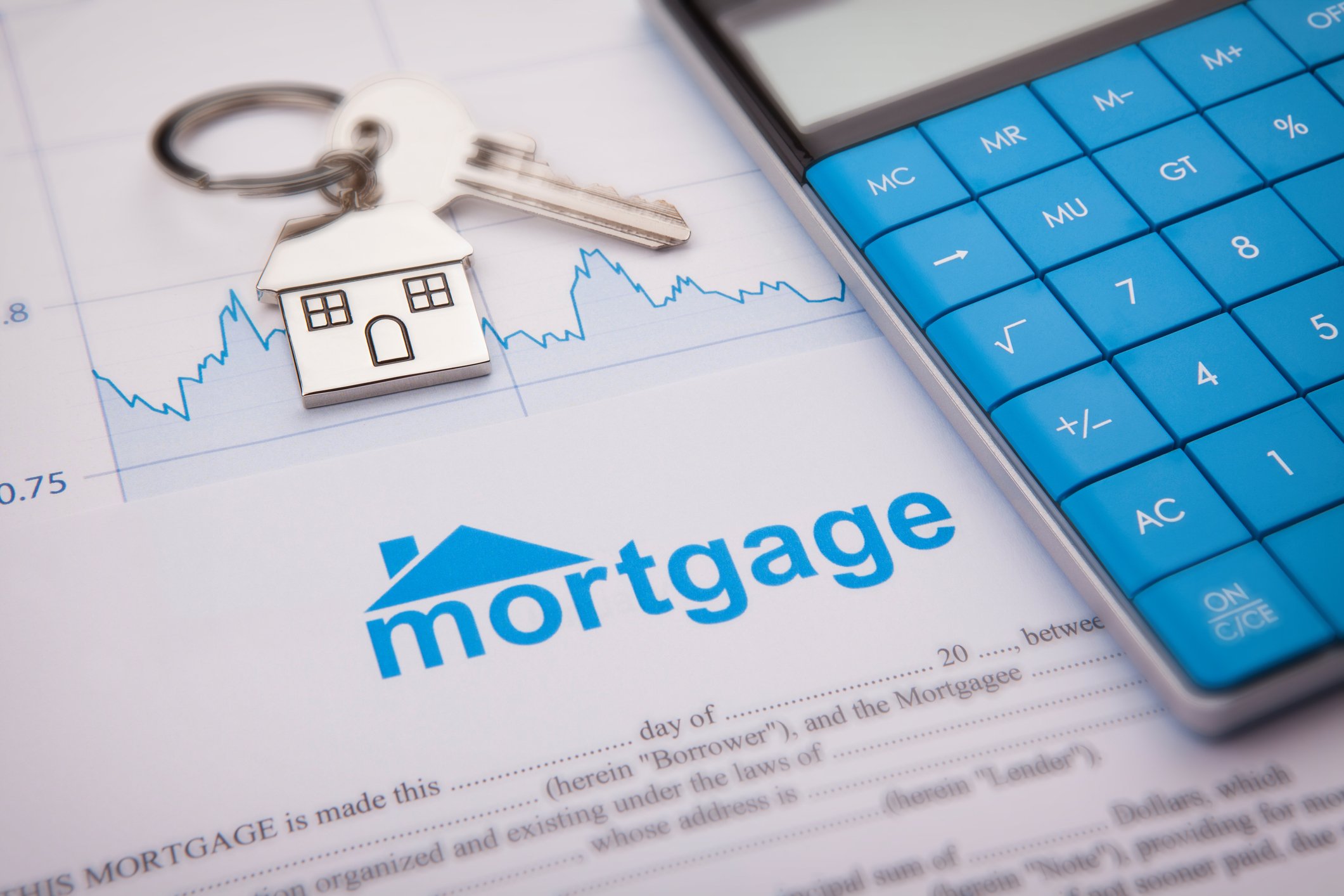 Photo of a mortgage document, a calculator, and a set of keys