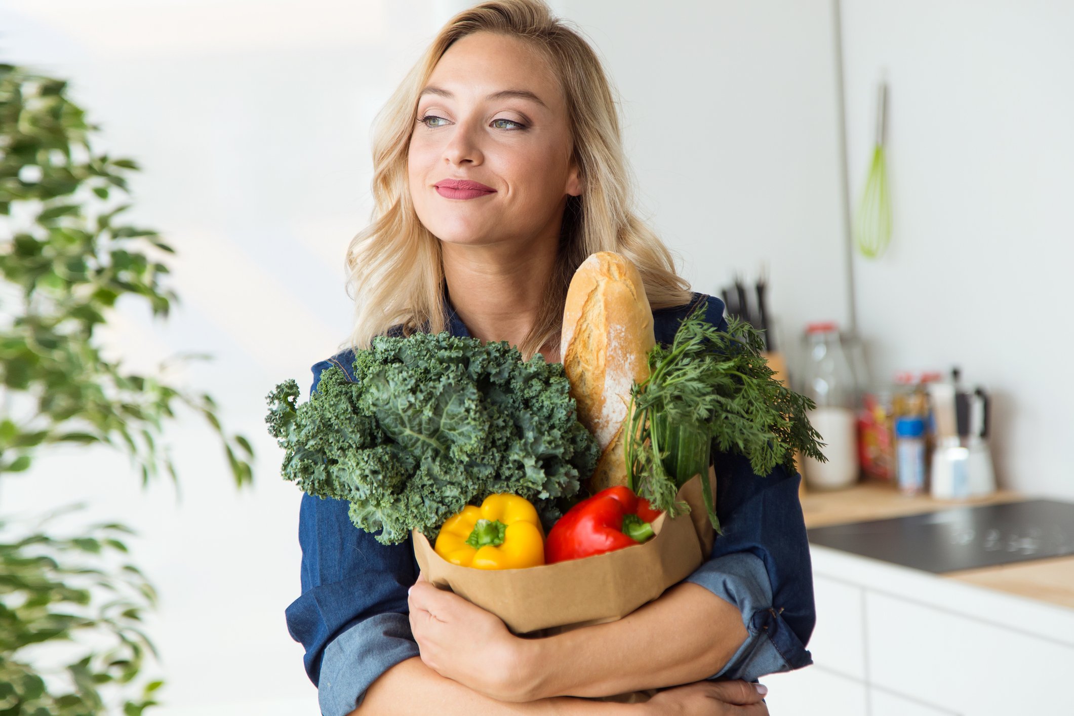Woman clutching a bag of groceries