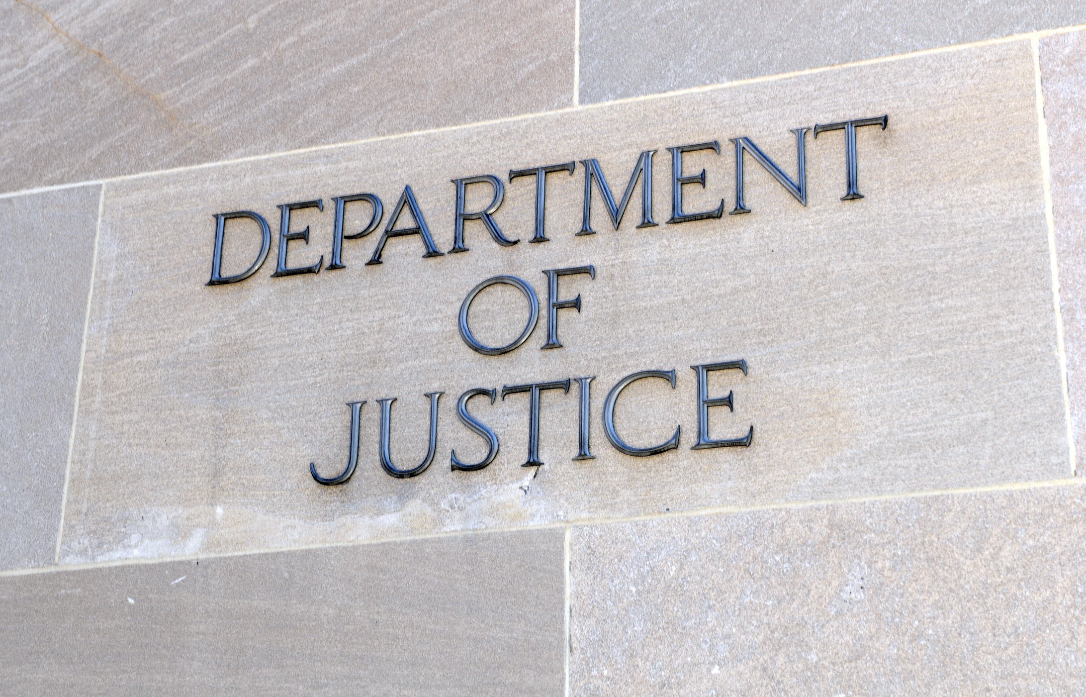 A Department of Justice sign on a building
