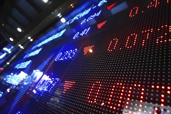 A digital stock ticker showing declining prices. 