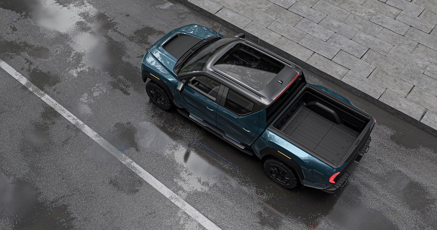 Nikola Badger pickup truck seen from above, on a road near a cobblestone patio.