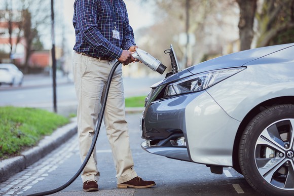 Man charging an electric car