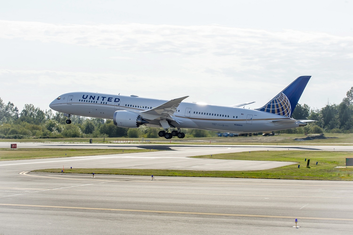 A United jet landing at an airport.