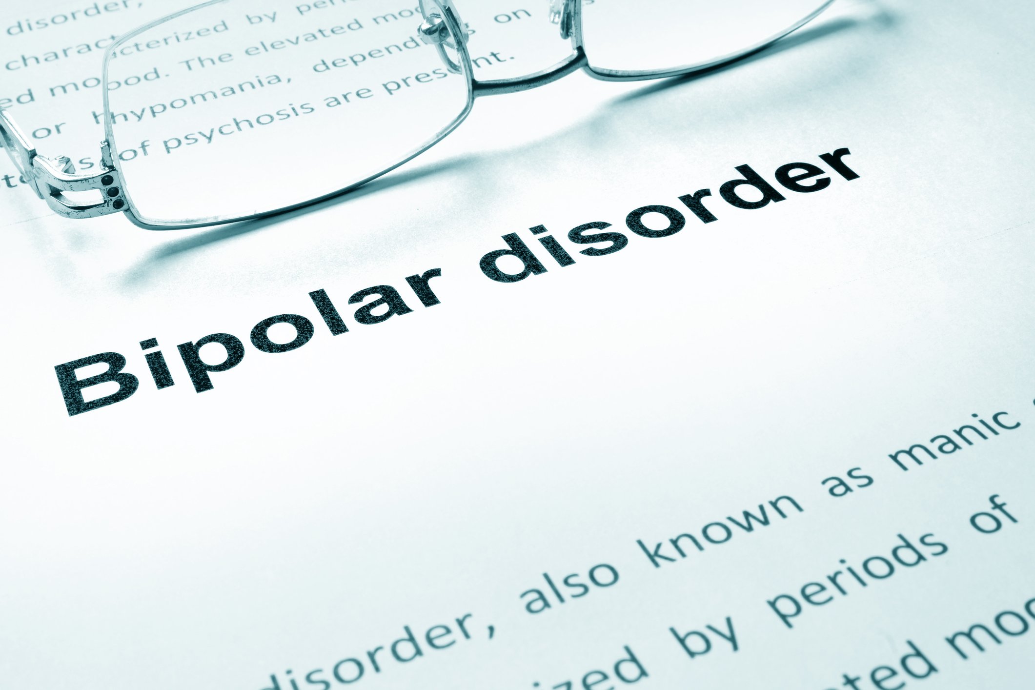 Document explaining bipolar disorder with eyeglasses on top of it
