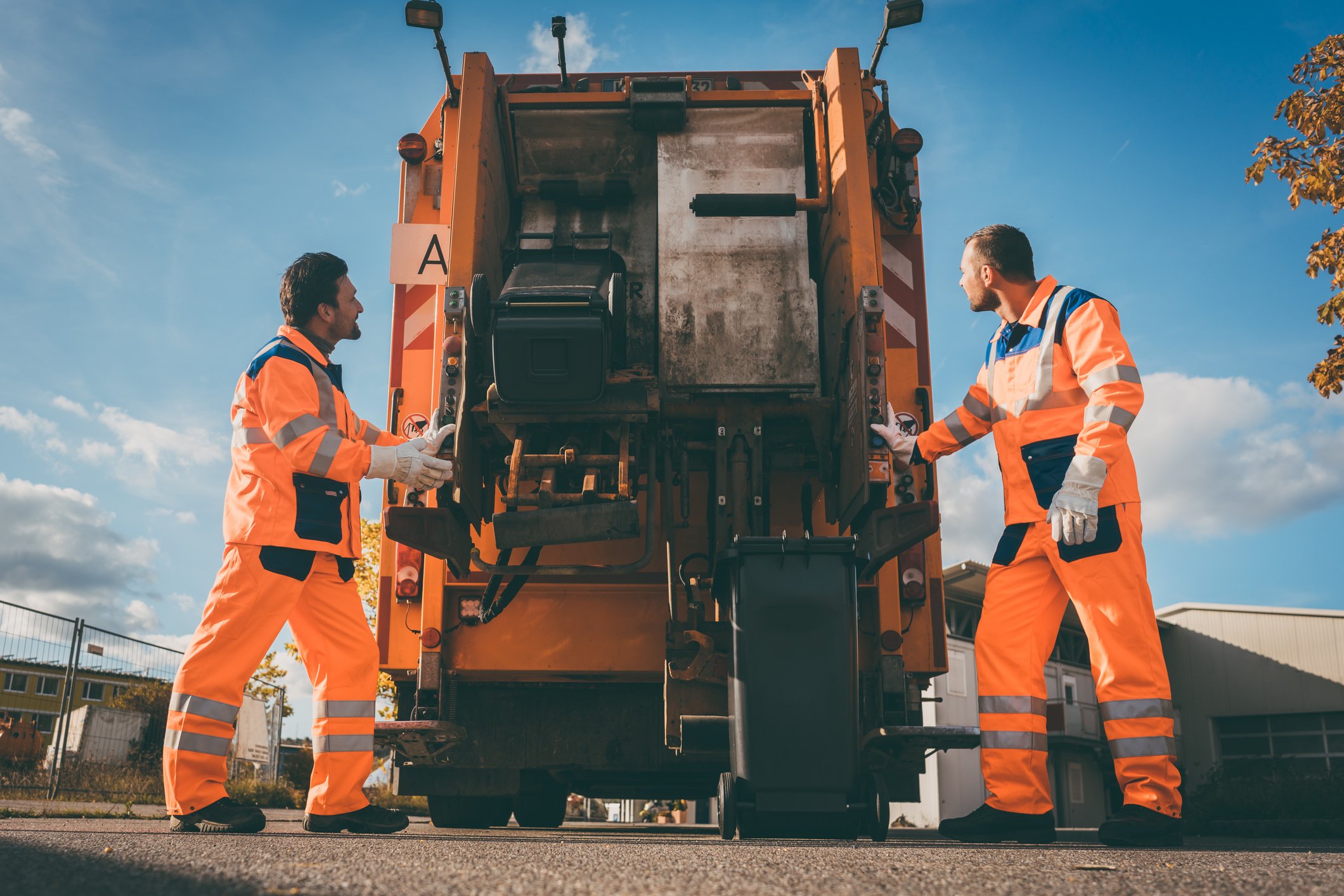 Workers Filling Garbage Truck