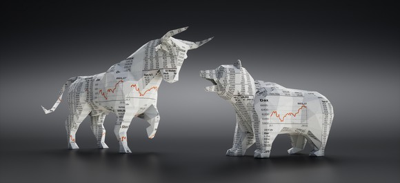 Paper bull and bear made out of the stock market section of the newspaper.