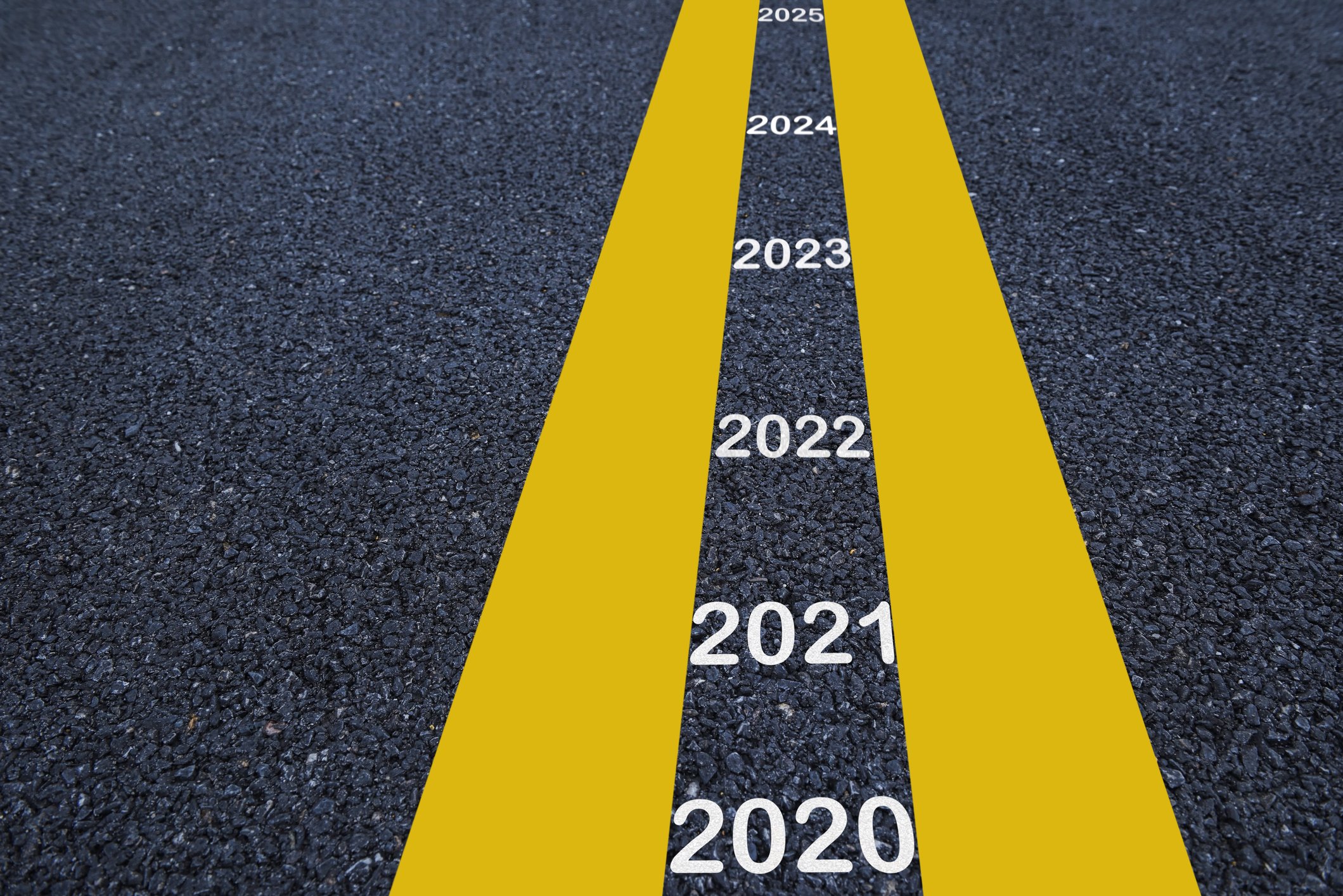 2020 through 2025 painted between yellow road lines.