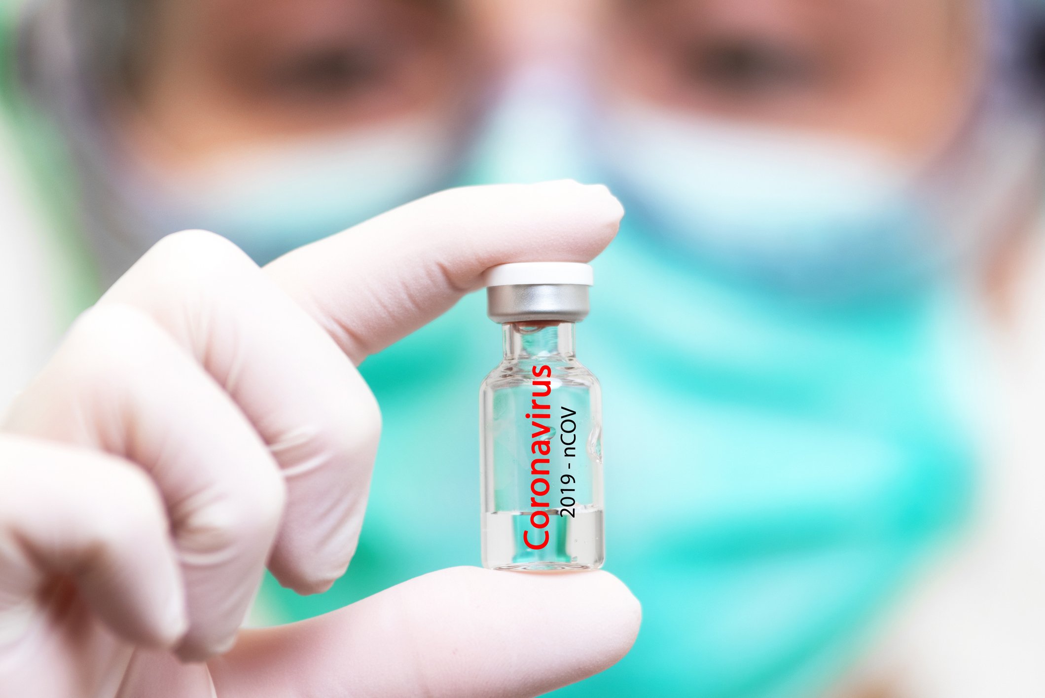 Researcher holds up vial labeled CORONAVIRUS