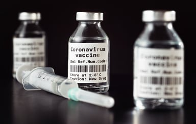 3 coronavirus vaccine bottles with syringe