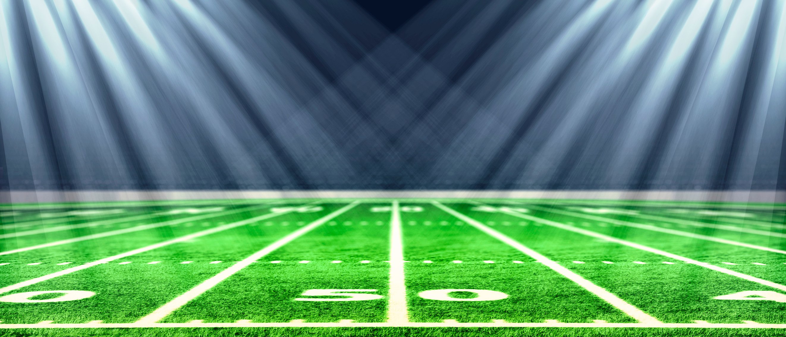 Lights are shining on a football field.