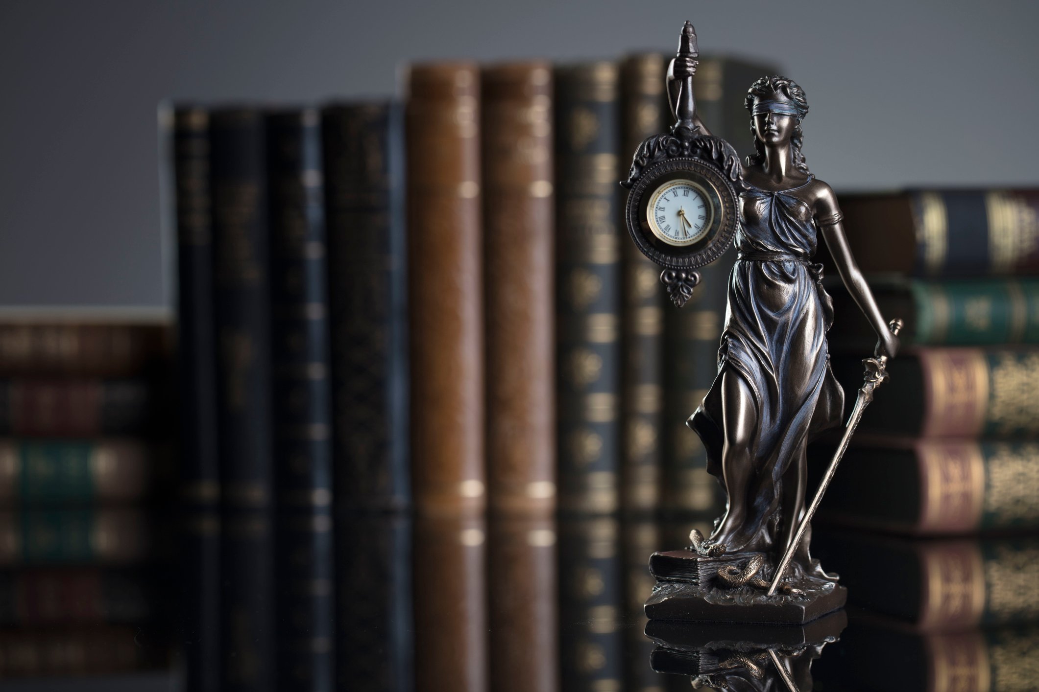 Statue of Justice holding a clock