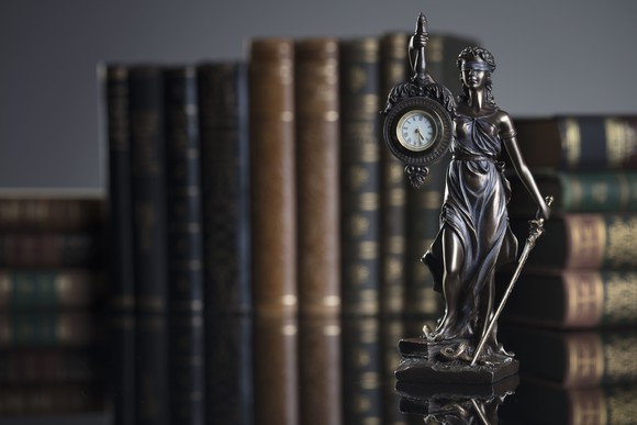 Statue of Justice holding a clock