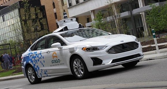 A Ford Fusion with ArgoAI logos and self-driving sensor hardware. 