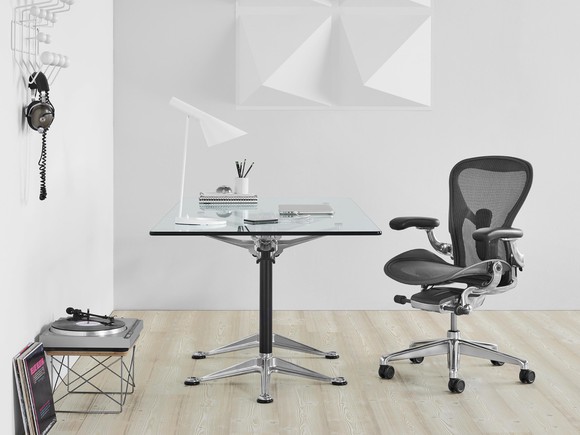 The Herman Miller Aeron chair next to desk.