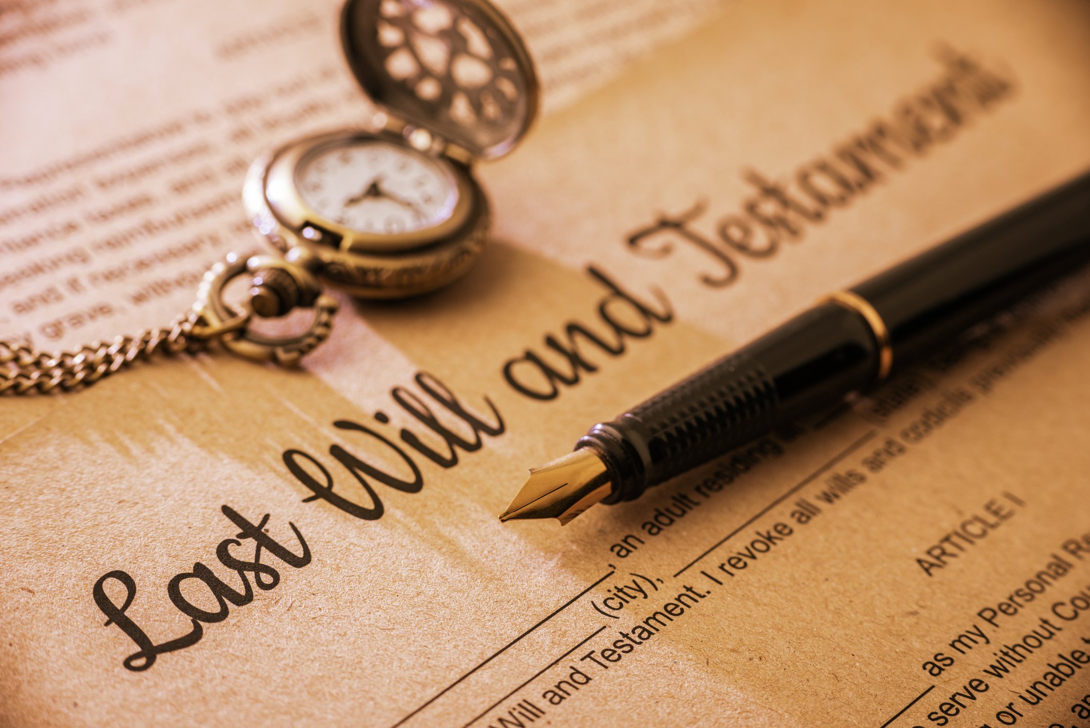 last will and testament with pen and watch.
