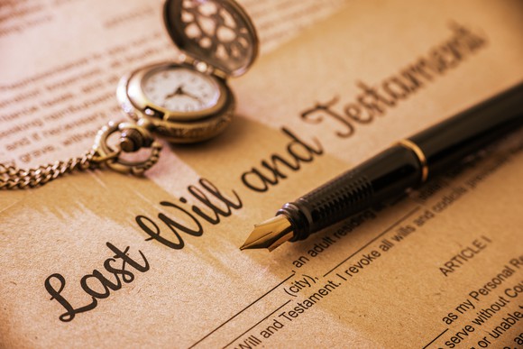 last will and testament with pen and watch.