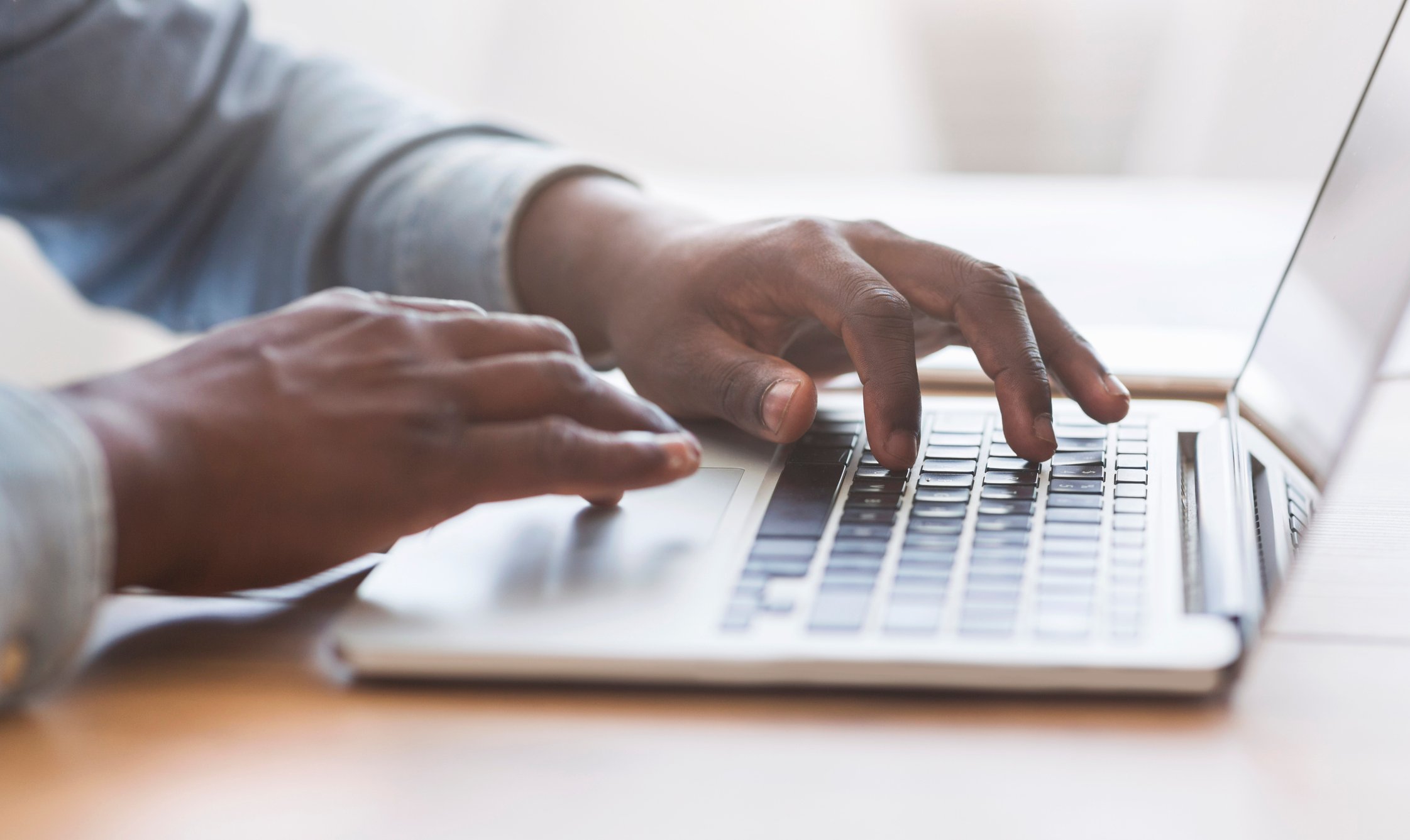 A man typing on a laptop.