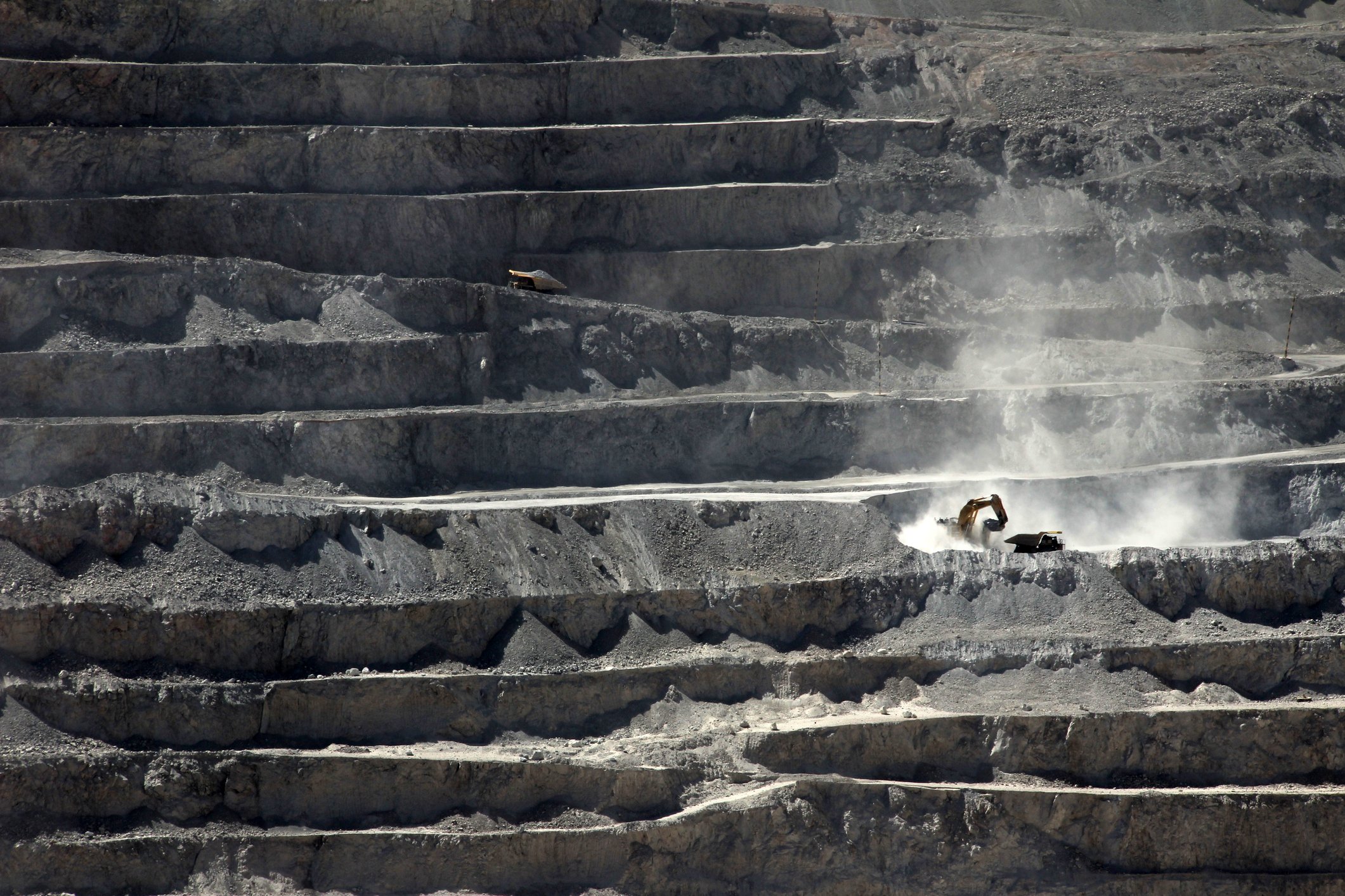 heavy equipment digging at an open pit mine