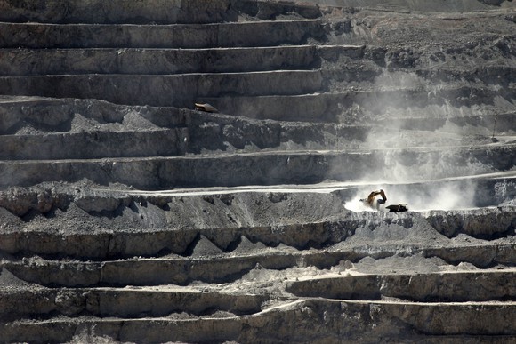 heavy equipment digging at an open pit mine