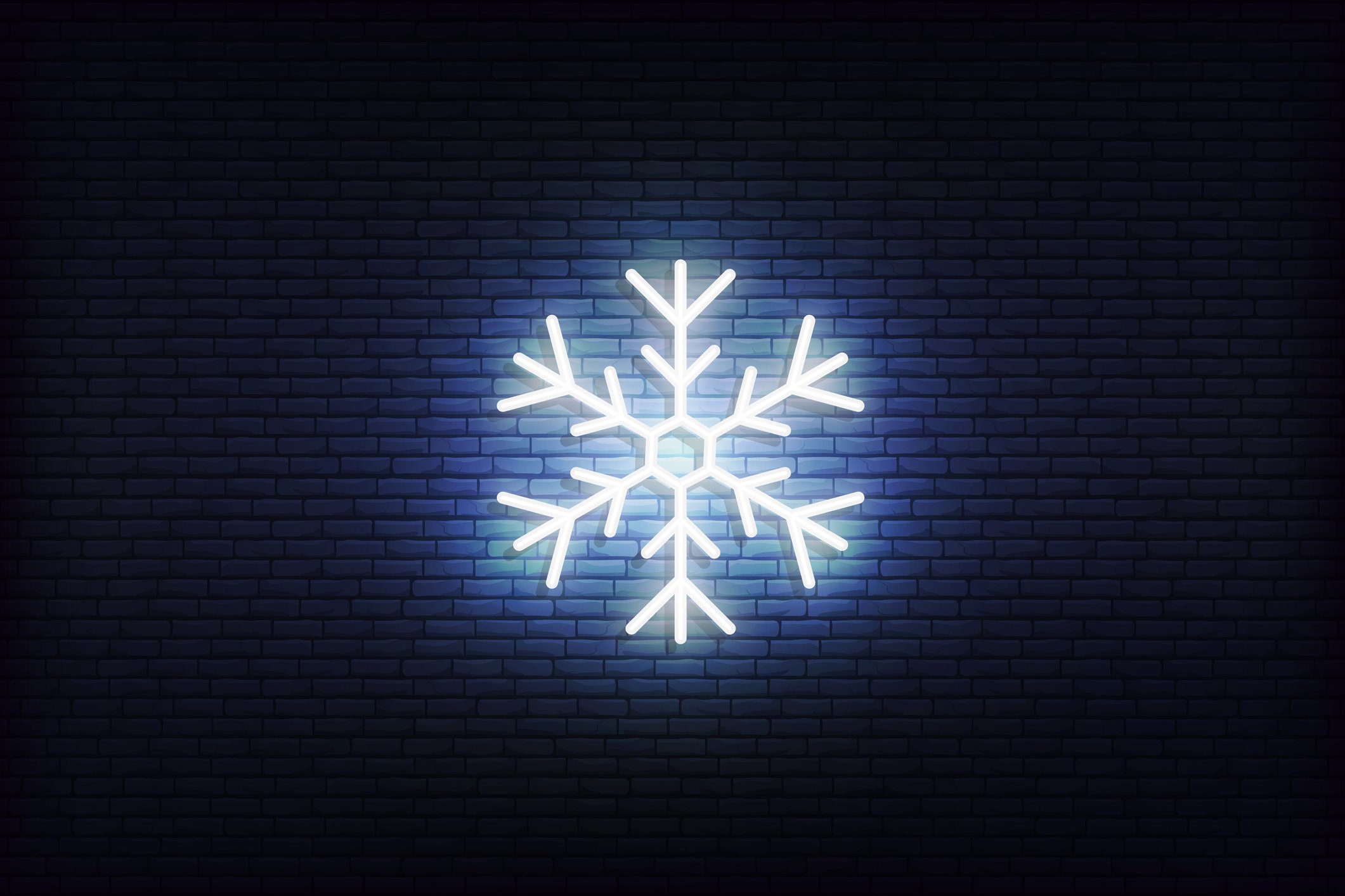 A snowflake illuminated against  a black background. 