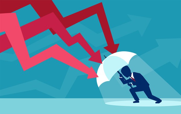 Vector of a businessman with umbrella defending himself from the falling red arrows of a stock market crash