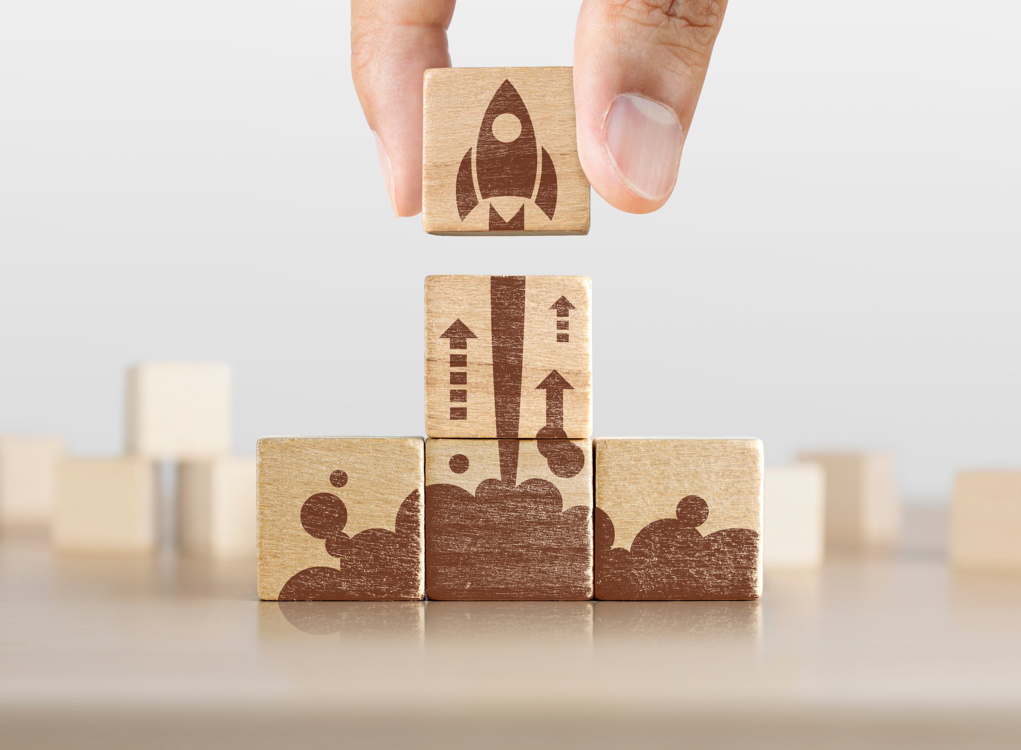 Wooden blocks forming a picture of a rocket taking off