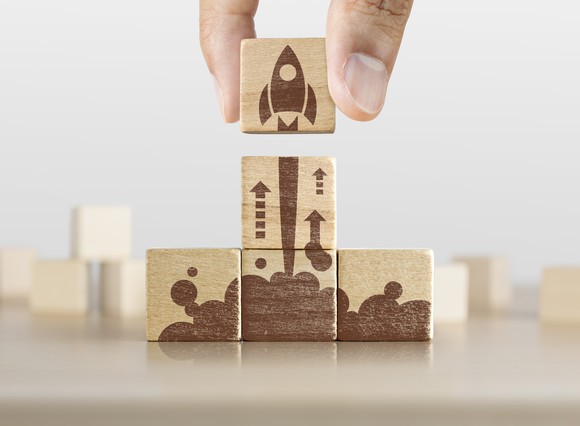 Wooden blocks forming a picture of a rocket taking off