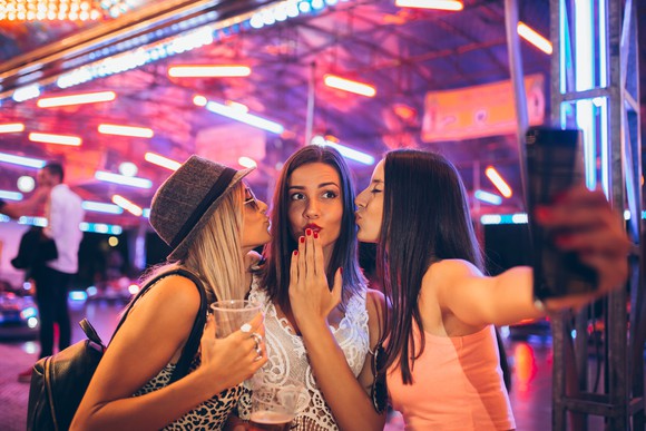 Three women take a selfie.