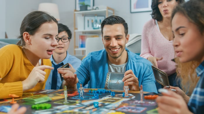 Diverse group of people playing a board game.