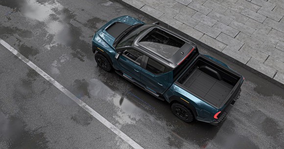Overhead view of Nikola Badger pickup truck on a road next to a cut-stone walkway.