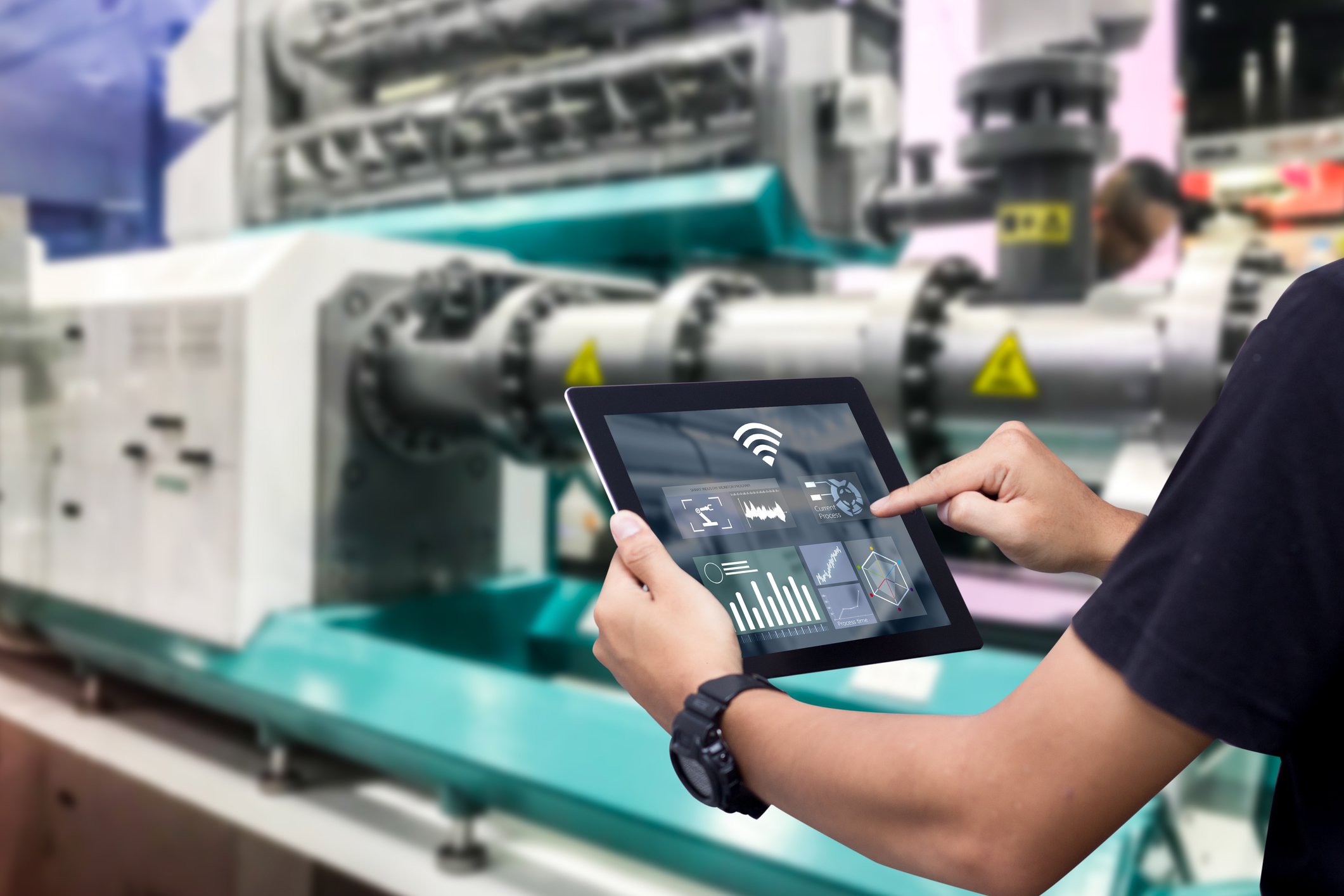 Someone using tablet in industrial setting